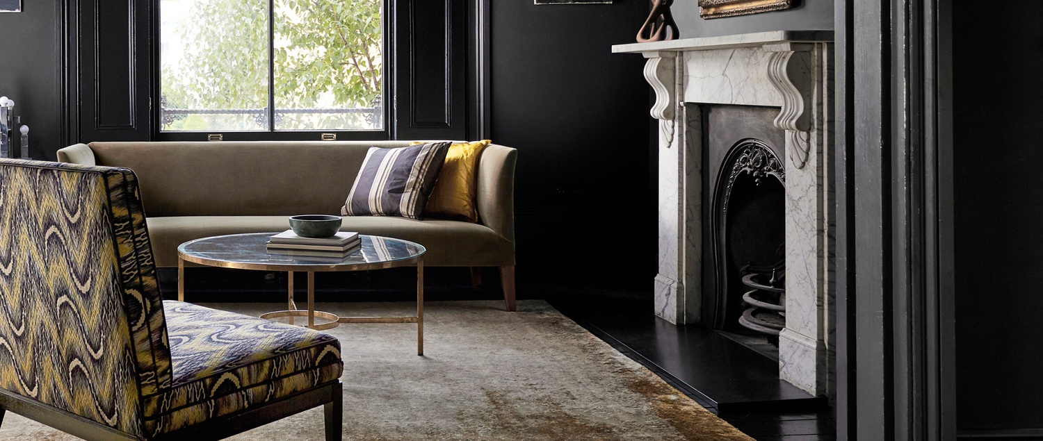 Vine black walls in lounge with yellow cushions